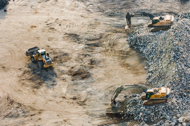 Three diggers working next to each other at a mine